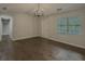 Open concept living room with a modern chandelier and natural light at 175 Stoneview Cir, Covington, GA 30016