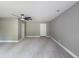 Expansive living room features neutral paint, modern ceiling fan, and plush carpeting at 175 Stoneview Cir, Covington, GA 30016