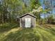 Exterior view of backyard storage shed with a white door, perfect for gardening and storage at 175 Stoneview Cir, Covington, GA 30016