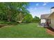 Well-manicured backyard with a patio area and lush green grass at 2265 Pemberton Pt, Buford, GA 30519
