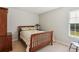 Cozy bedroom with wood furniture, neutral decor, and natural light at 2265 Pemberton Pt, Buford, GA 30519