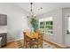 Cozy dining area with wood table, chairs, and view of the backyard at 2265 Pemberton Pt, Buford, GA 30519