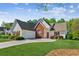 Well-maintained home with a two-car garage, brick accents, and a lush green lawn at 2265 Pemberton Pt, Buford, GA 30519