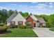 Charming home featuring a manicured lawn, red shutters, and a brick accent wall at 2265 Pemberton Pt, Buford, GA 30519
