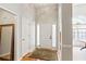 Bright foyer with wood flooring, a rug, and views of an arched window at 2265 Pemberton Pt, Buford, GA 30519