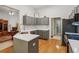 Modern kitchen featuring gray cabinets, quartz countertops, and hardwood floors at 2265 Pemberton Pt, Buford, GA 30519