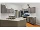 Modern kitchen featuring gray cabinets, stainless steel appliances, and quartz countertops at 2265 Pemberton Pt, Buford, GA 30519