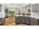 Open kitchen featuring gray cabinets, stainless steel appliances, and hardwood floors at 2265 Pemberton Pt, Buford, GA 30519