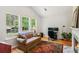 Bright living room with large windows, workspace, and cozy sofa at 2265 Pemberton Pt, Buford, GA 30519