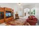 Bright living room with large entertainment center, plush seating, and neutral walls at 2265 Pemberton Pt, Buford, GA 30519