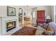 Charming living room with fireplace, hardwood floors, and comfortable sofa at 2265 Pemberton Pt, Buford, GA 30519