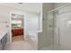 Main bathroom with soaking tub, glass enclosed shower, and neutral color palette at 2265 Pemberton Pt, Buford, GA 30519