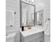 Bright bathroom featuring shiplap walls, modern vanity, and decorative mirror at 2329 Wavetree Nw Ln, Acworth, GA 30101