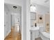 Stylish bathroom with shiplap walls, pedestal sink, and tub/shower combo at 2329 Wavetree Nw Ln, Acworth, GA 30101