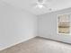 Neutral bedroom featuring plush carpeting, a ceiling fan, and natural light through the window at 2329 Wavetree Nw Ln, Acworth, GA 30101