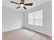 Bright bedroom featuring plush carpeting, a ceiling fan, and a large window at 2329 Wavetree Nw Ln, Acworth, GA 30101