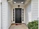 Elegant black front door framed by sidelights and white trim at 2329 Wavetree Nw Ln, Acworth, GA 30101