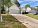 Charming single-story home with a well-manicured lawn and attached two-car garage and driveway at 2329 Wavetree Nw Ln, Acworth, GA 30101