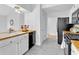Bright kitchen featuring white cabinets, modern appliances, and wood countertops at 2329 Wavetree Nw Ln, Acworth, GA 30101