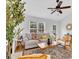 Bright living room boasts hardwood floors, modern furniture, and a ceiling fan at 2329 Wavetree Nw Ln, Acworth, GA 30101