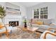 Cozy living room has natural light, a fireplace, and stylish decor at 2329 Wavetree Nw Ln, Acworth, GA 30101