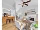 Open-concept living space includes a modern fireplace, breakfast bar, and dining area at 2329 Wavetree Nw Ln, Acworth, GA 30101