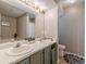 Bathroom featuring a double sink vanity and tub-shower combo at 3805 Forsythia Way, Douglasville, GA 30135