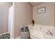 Bright bathroom features a soaking tub, decorative stool, and neutral wall color at 3805 Forsythia Way, Douglasville, GA 30135