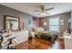 Cozy bedroom with wood floors and a ceiling fan at 3805 Forsythia Way, Douglasville, GA 30135