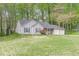 Traditional home featuring a two-car garage, neat lawn, and shrubbery on the front porch at 3805 Forsythia Way, Douglasville, GA 30135