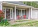 Inviting front porch with comfortable seating, a small table, and a view of the well-kept lawn at 3805 Forsythia Way, Douglasville, GA 30135