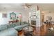 Open-concept living room featuring fireplace, hardwood floors and view to dining area at 3805 Forsythia Way, Douglasville, GA 30135