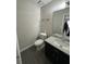 Updated bathroom features dark vanity, granite countertops, and updated fixtures at 4049 Heritage Valley Ct, Norcross, GA 30093
