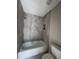 Modern bathroom featuring stylish gray tile in the shower and sleek fixtures at 4049 Heritage Valley Ct, Norcross, GA 30093