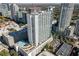 An aerial view showing the modern building with a rooftop pool amidst a bustling cityscape at 860 Peachtree Ne St # 2118, Atlanta, GA 30308