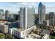 Aerial view featuring a high-rise building with a rooftop pool and panoramic city vistas at 860 Peachtree Ne St # 2118, Atlanta, GA 30308