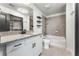 Modern bathroom with granite counters, a soaking tub, and sleek fixtures at 860 Peachtree Ne St # 2118, Atlanta, GA 30308