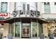 A modern condo building entrance with floor-to-ceiling windows and clear signage offers a welcoming experience at 860 Peachtree Ne St # 2118, Atlanta, GA 30308