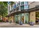 Elegant building entrance with modern design, prominent signage, and manicured plants at 860 Peachtree Ne St # 2118, Atlanta, GA 30308