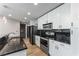 Modern kitchen featuring granite counters, black backsplash, and stainless steel appliances at 860 Peachtree Ne St # 2118, Atlanta, GA 30308