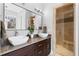 Luxurious bathroom featuring a double vanity, walk-in shower, and modern finishes at 1181 Cleburne Ne Ave, Atlanta, GA 30307