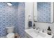 Stylish half-bathroom with patterned wallpaper, sleek sink, and modern design elements at 1181 Cleburne Ne Ave, Atlanta, GA 30307