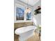 Chic bathroom featuring a freestanding tub, mosaic tile, and stylish lighting fixtures at 1181 Cleburne Ne Ave, Atlanta, GA 30307