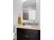 Modern half bathroom featuring granite countertop and dark wood cabinets at 1181 Cleburne Ne Ave, Atlanta, GA 30307