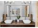 Elegant bathroom vanity with dual vessel sinks, modern fixtures, and a large mirror at 1181 Cleburne Ne Ave, Atlanta, GA 30307