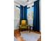 Inviting corner nook with blue drapes, a velvet chair, and a hide rug on hardwood floors at 1181 Cleburne Ne Ave, Atlanta, GA 30307