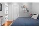 Cozy bedroom featuring a plush blue quilt and framed artwork accents on gray walls at 1181 Cleburne Ne Ave, Atlanta, GA 30307