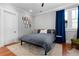 Stylish bedroom with a cozy bed, accent wall decor, and a comfortable sitting area by the window at 1181 Cleburne Ne Ave, Atlanta, GA 30307