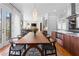 Open dining room with a modern light fixture, wooden table, and seamless flow to the living area at 1181 Cleburne Ne Ave, Atlanta, GA 30307
