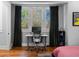 Functional home office featuring a modern desk setup, stylish curtains, and hardwood floors at 1181 Cleburne Ne Ave, Atlanta, GA 30307